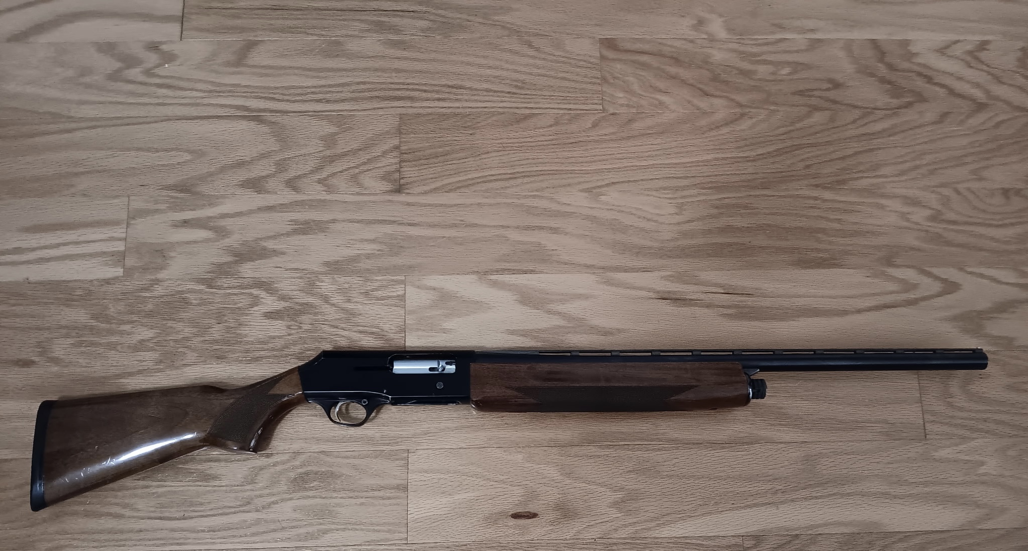 Wooden shotgun on wooden floor.