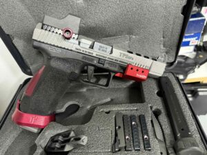Handgun with accessories in protective case.
