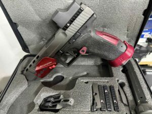 Pistol in foam case with accessories.