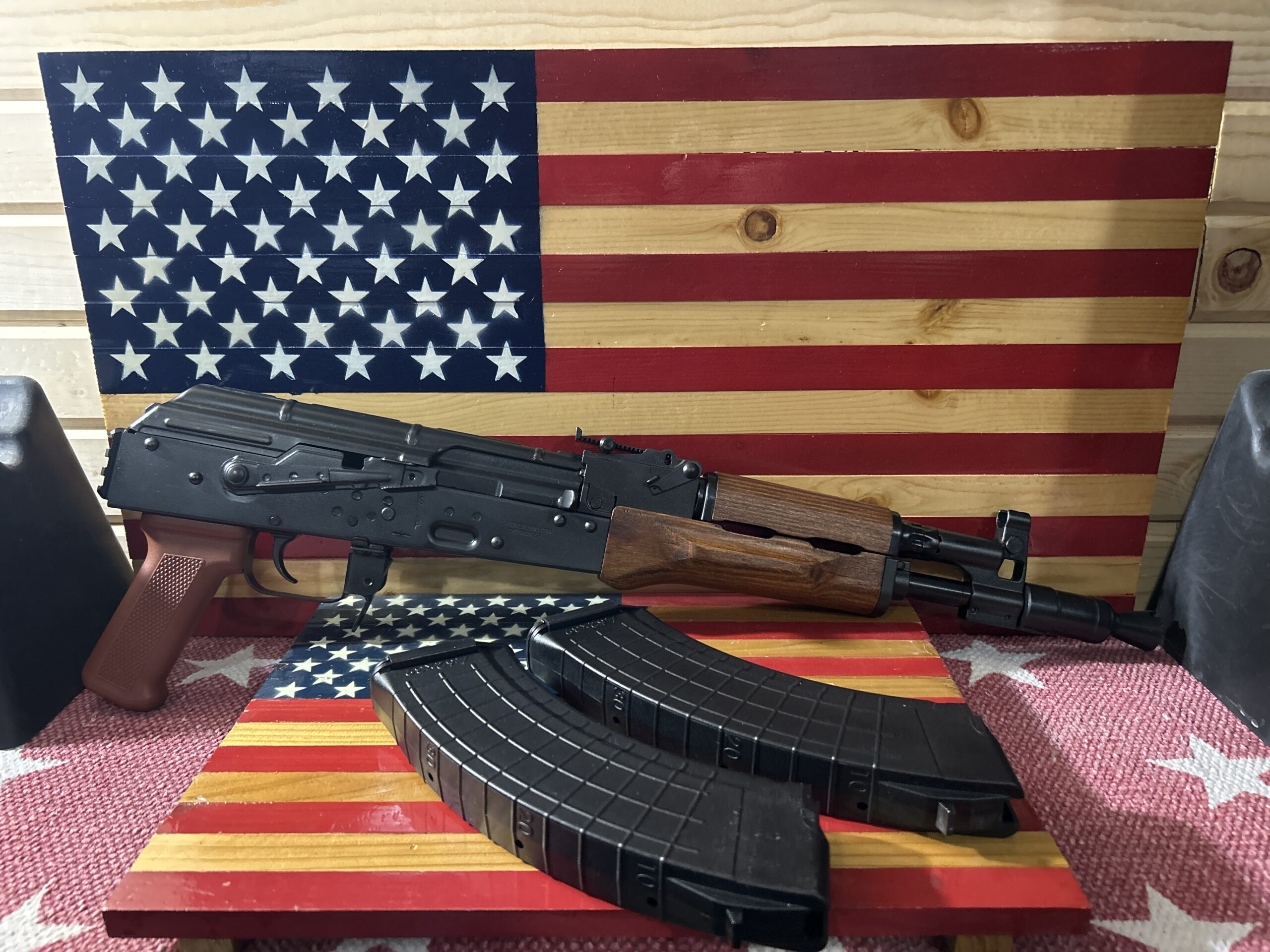 Rifle and magazines on American flag backdrop