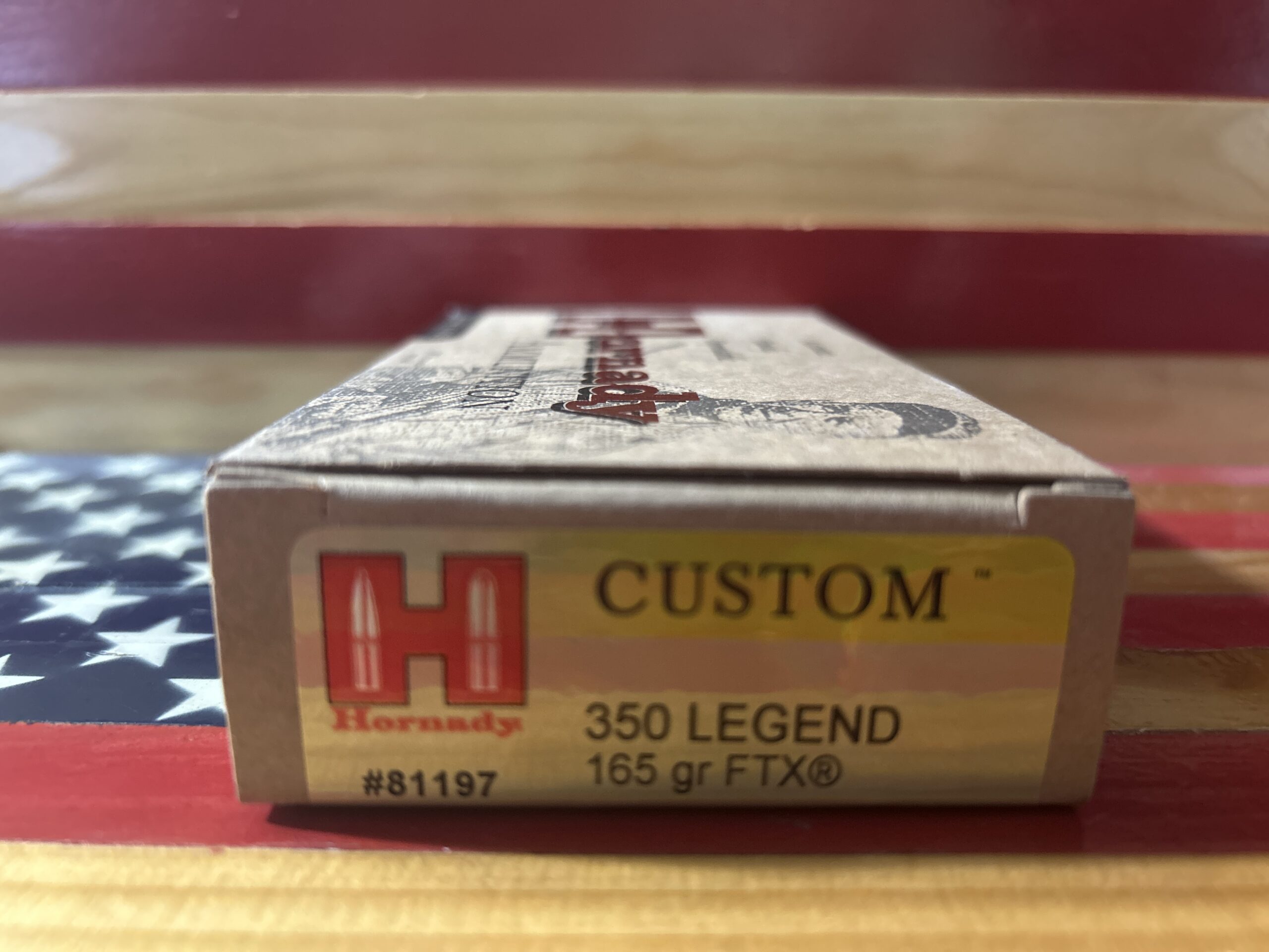 Hornady 350 Legend ammunition box on flag background.