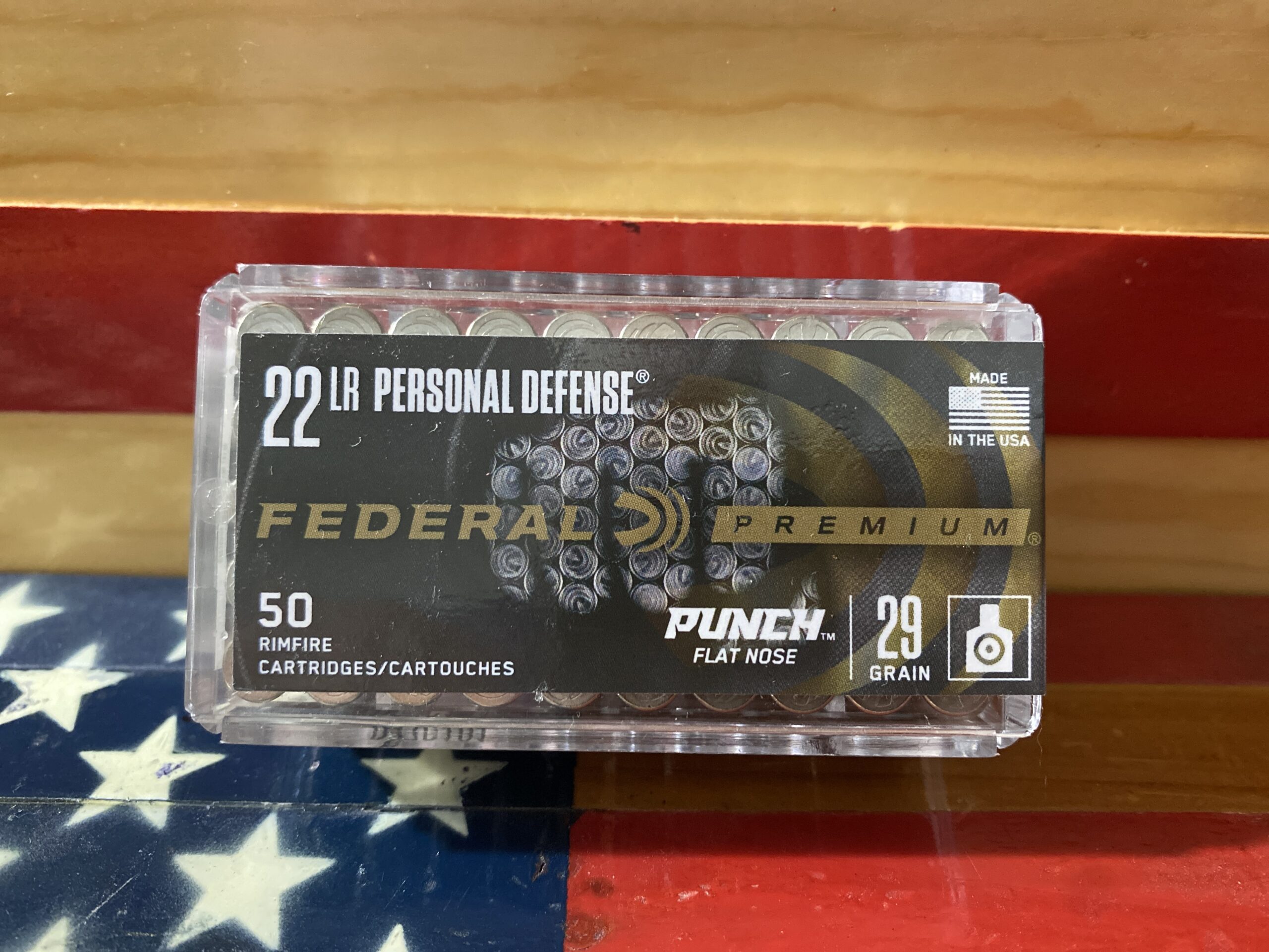Federal .22 LR ammo box on flag background.