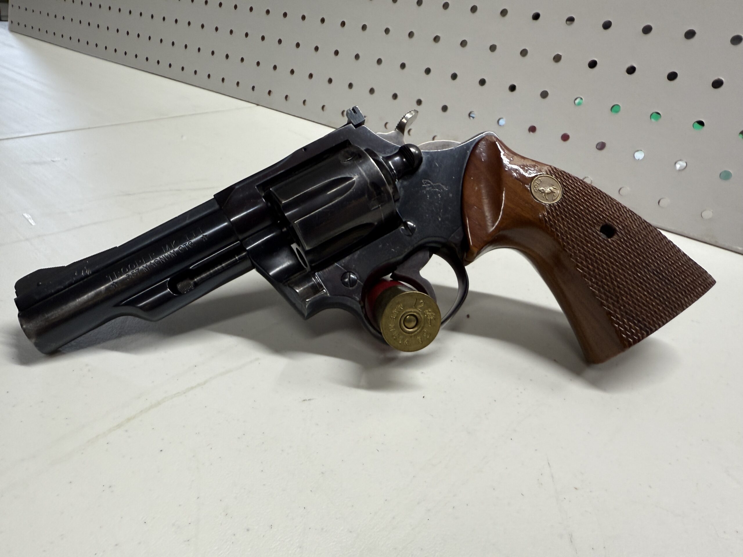 Revolver revolver with wood grip on table.