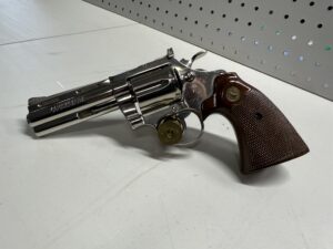 Revolver gun with wooden handle on table