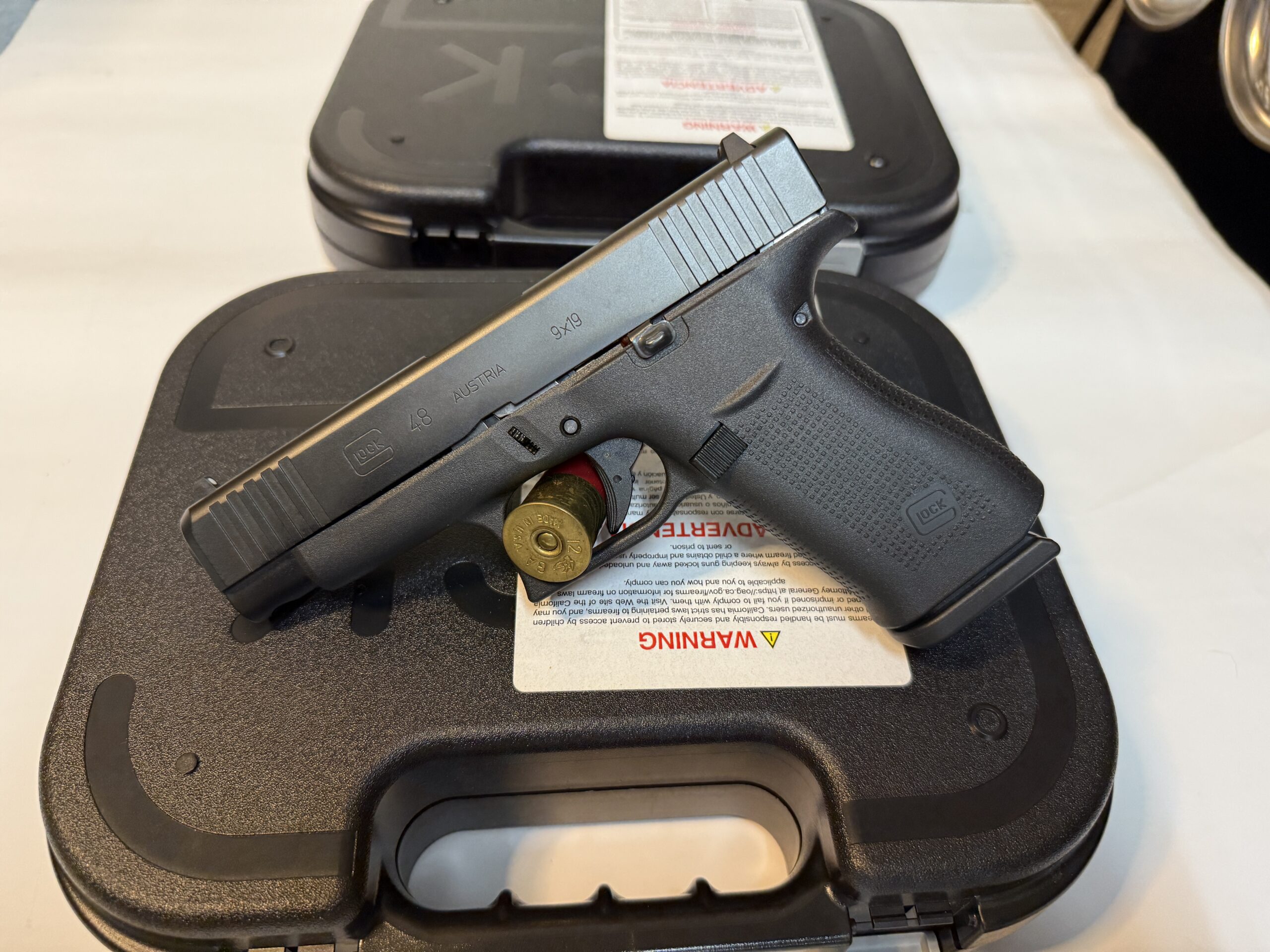 Black handgun with ammunition on case