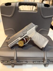 Handgun on top of a gray case.