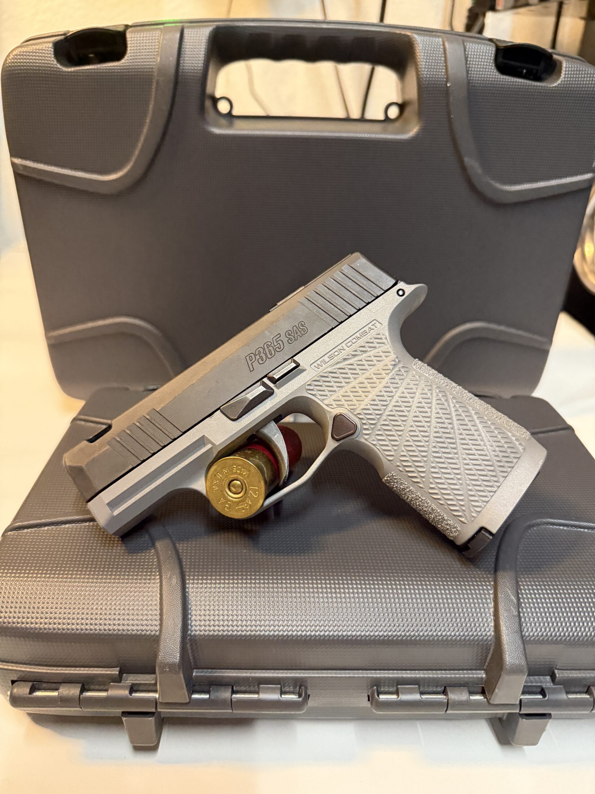 Handgun on top of a gray case.