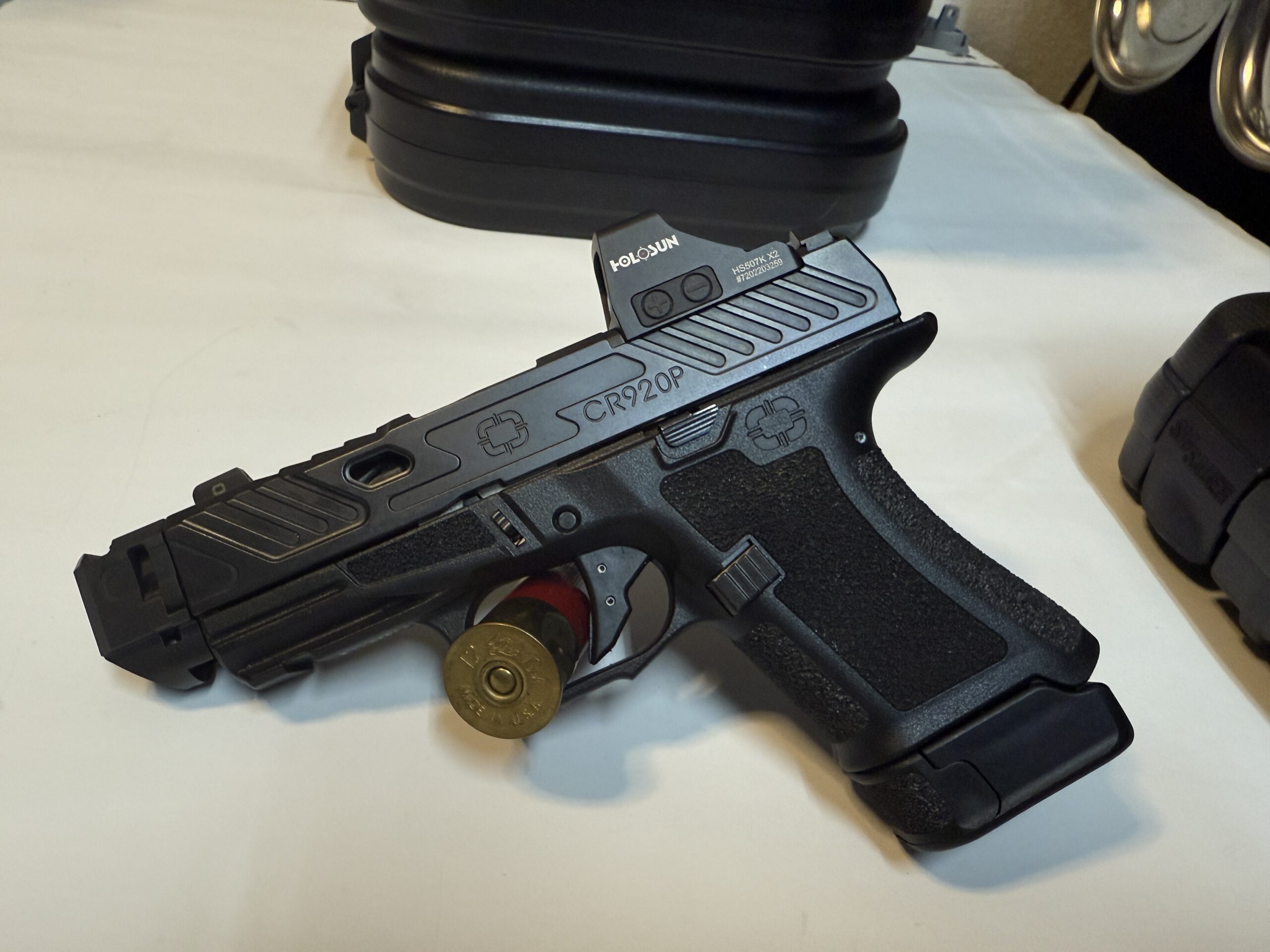 Black semi-automatic handgun on display table.