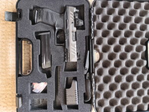 Pistol and accessories in foam gun case
