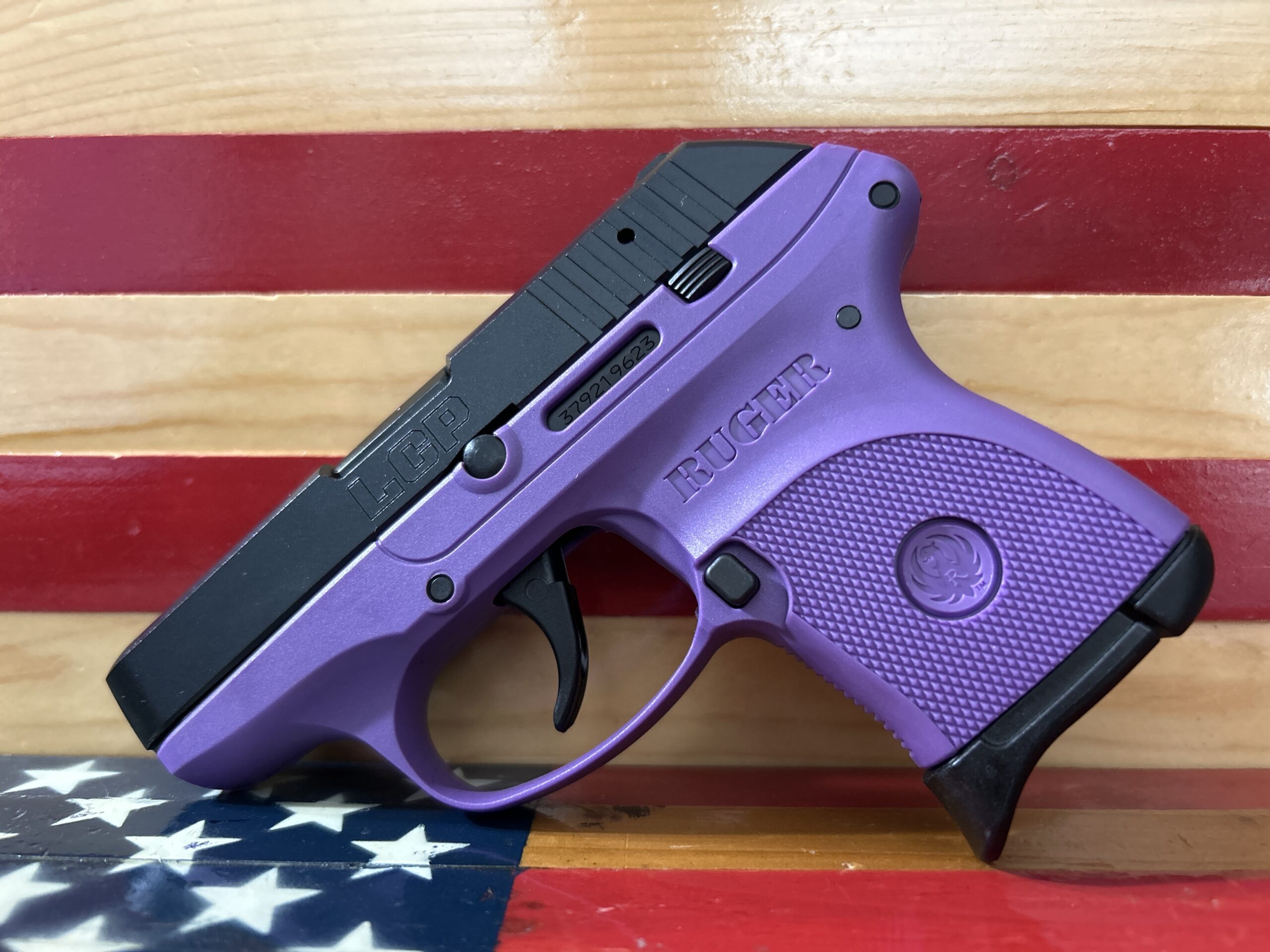 Purple Ruger handgun on American flag background.