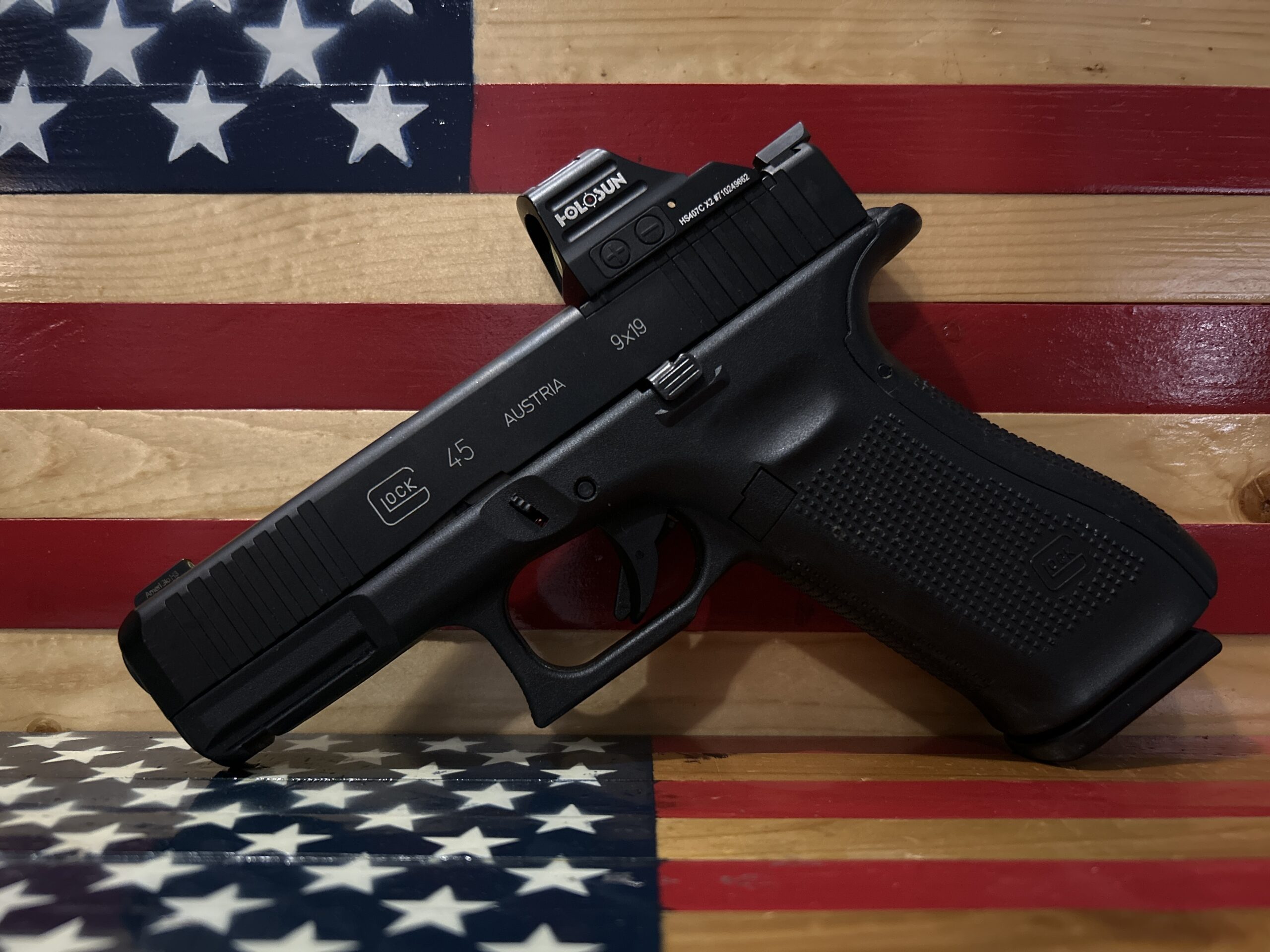 Handgun against American flag background.