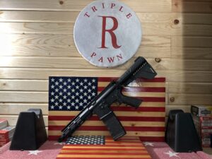 Rifle displayed on American flag backdrop