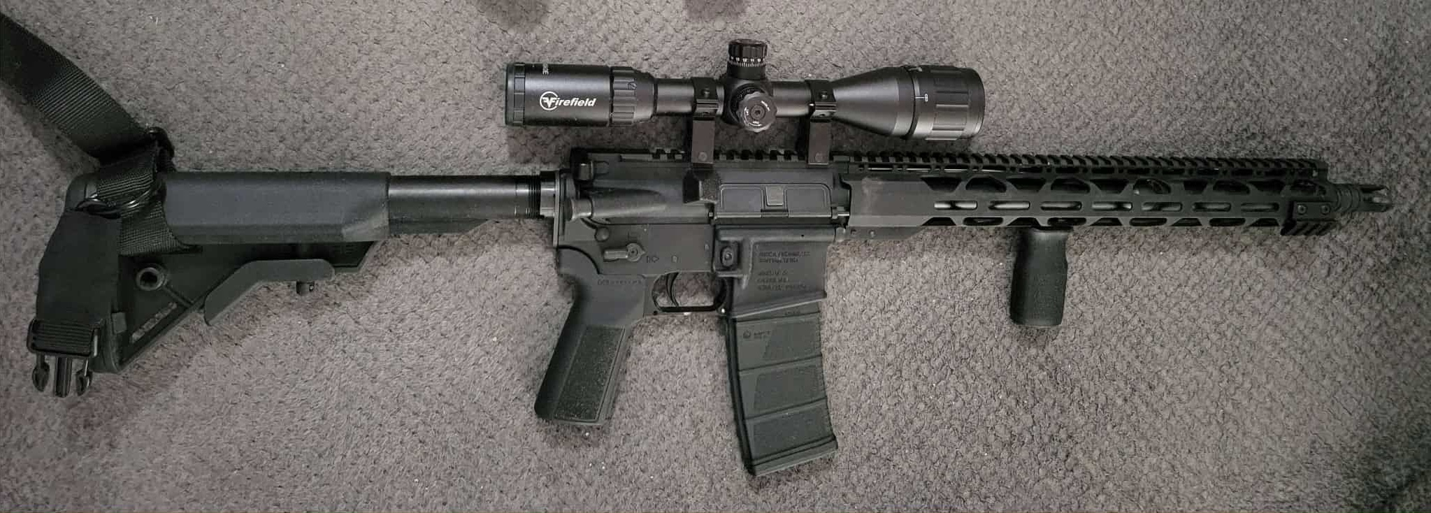 Rifle with scope on carpet background