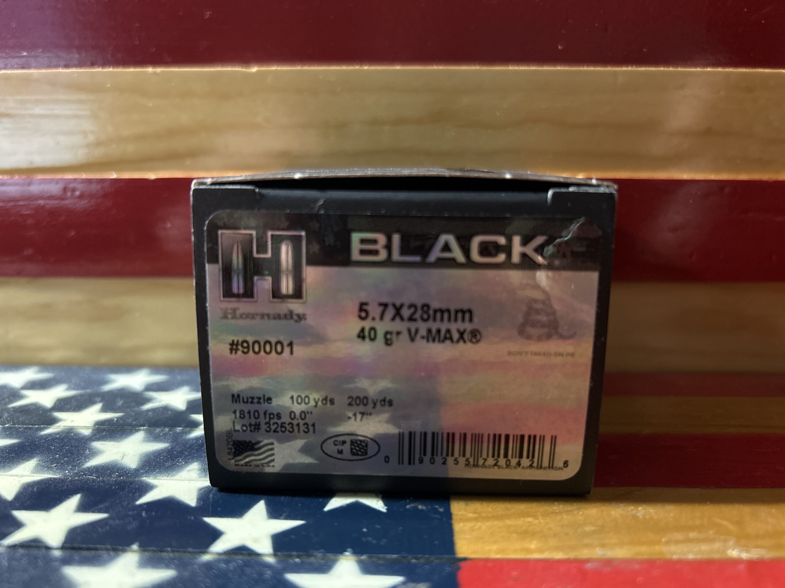 Hornady 5.7x28mm ammunition box on flag background.