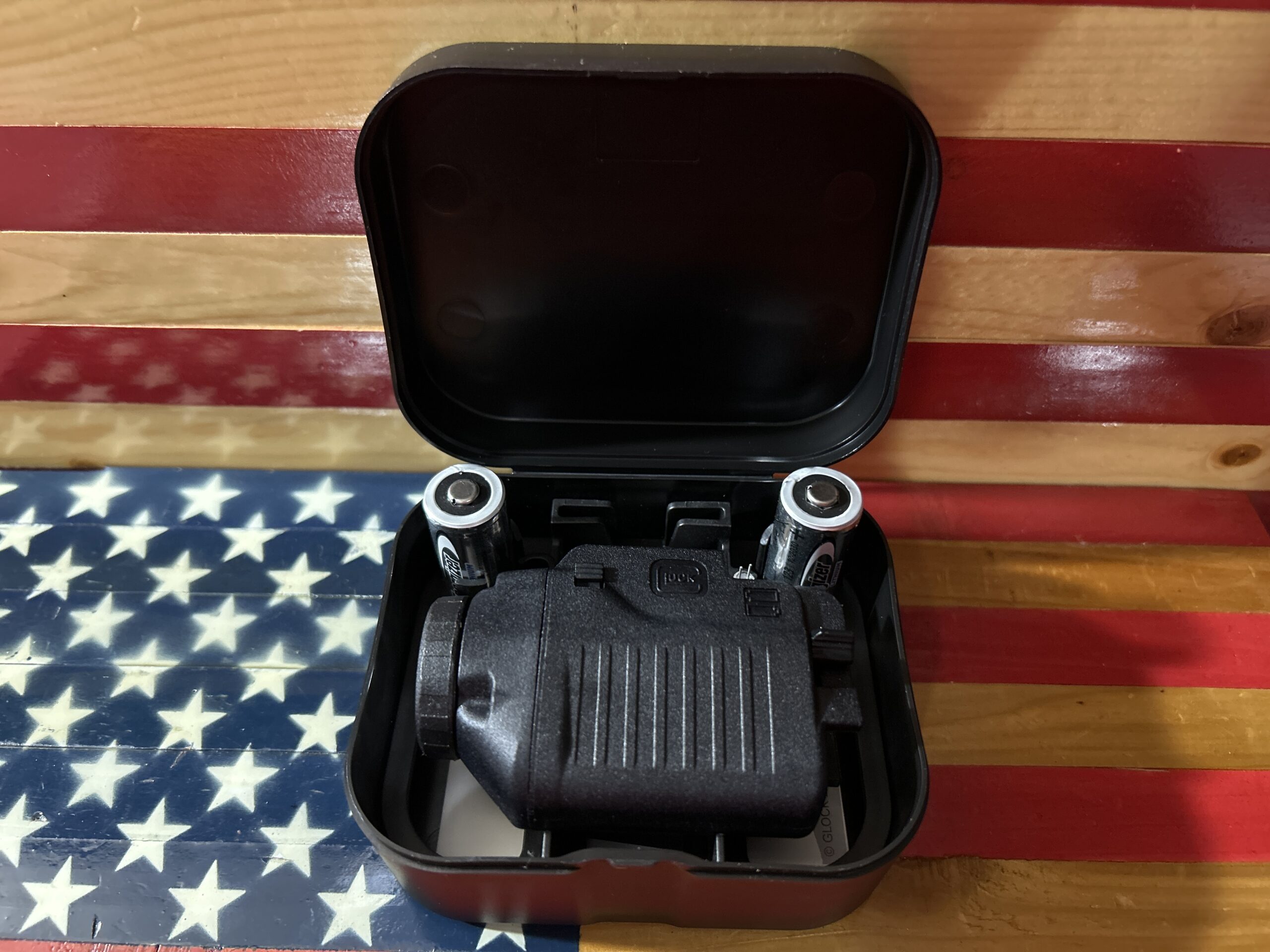 Box with a scope and batteries on flag