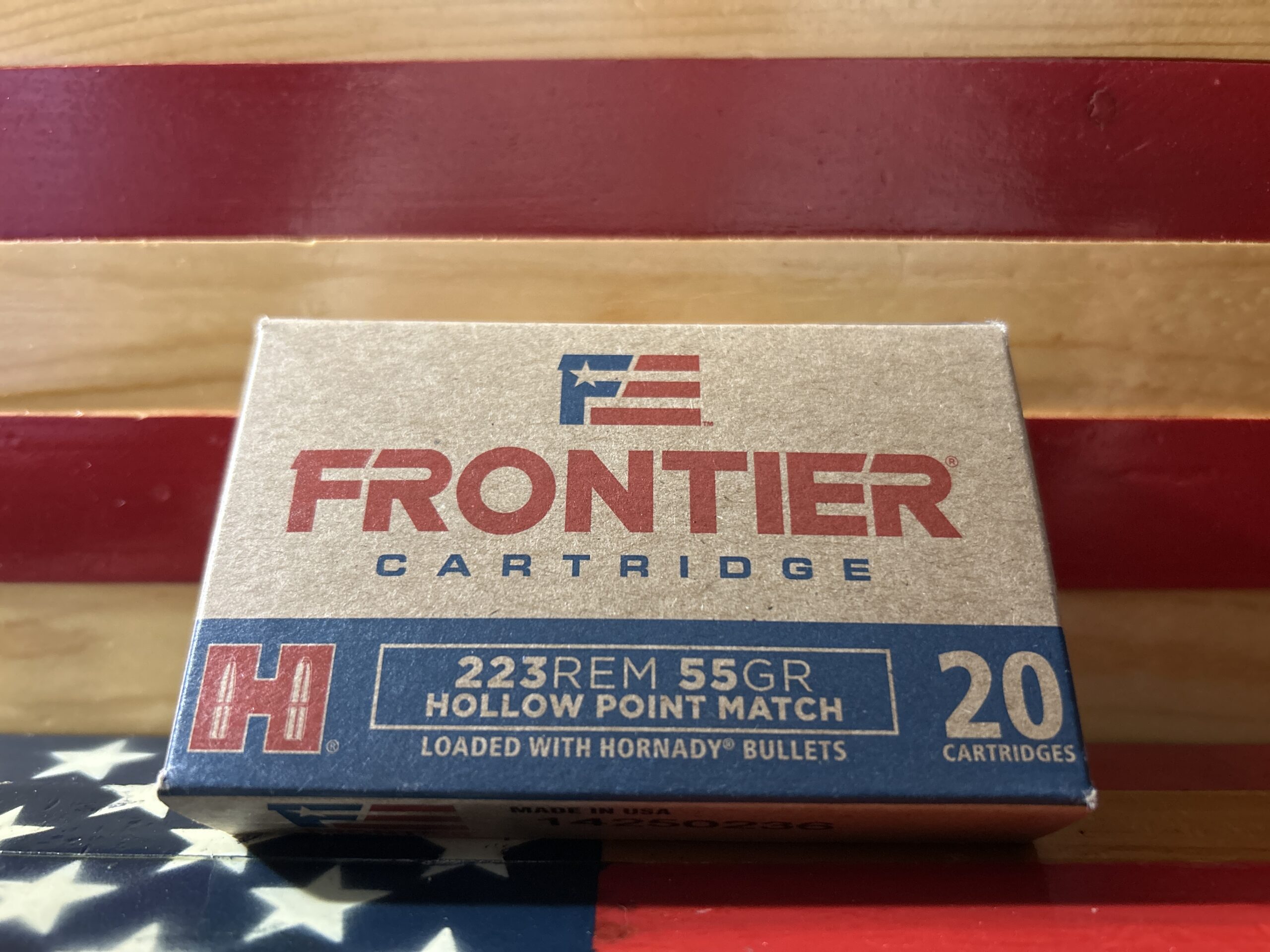Frontier cartridge box on American flag background.