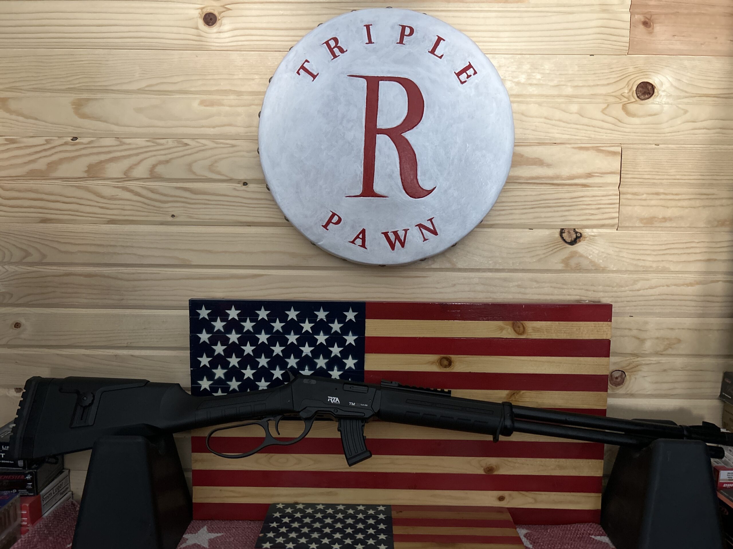 Rifle displayed with American flag background.